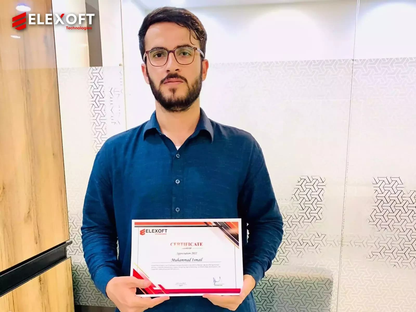 IT services company employee holding an achievement award